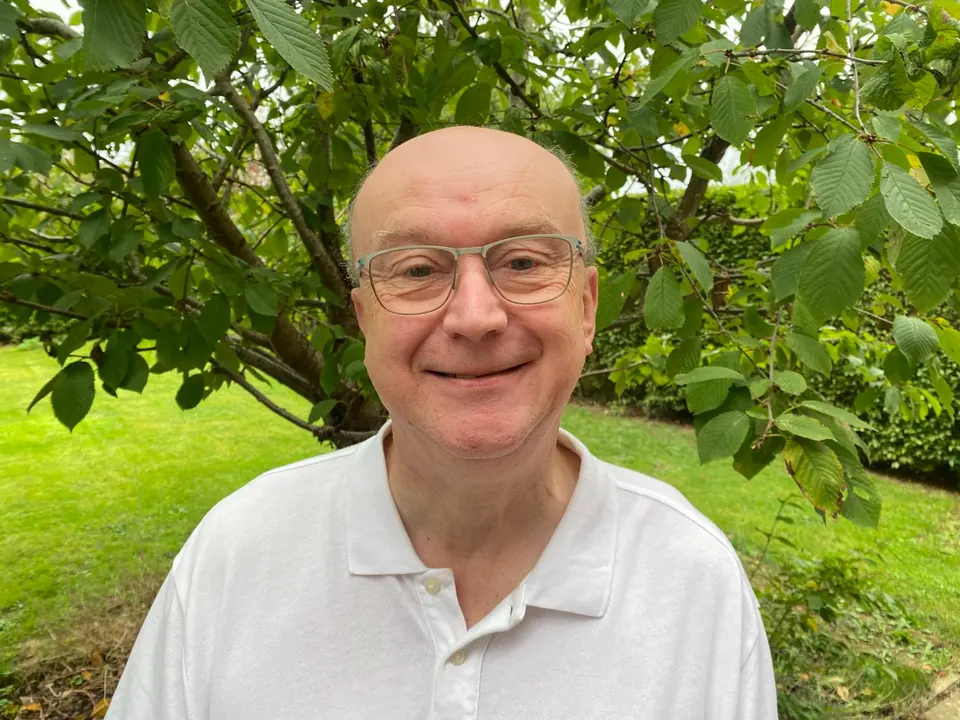 Richard Crawshaw of The Edge Home and Garden, standing in a garden under a tree